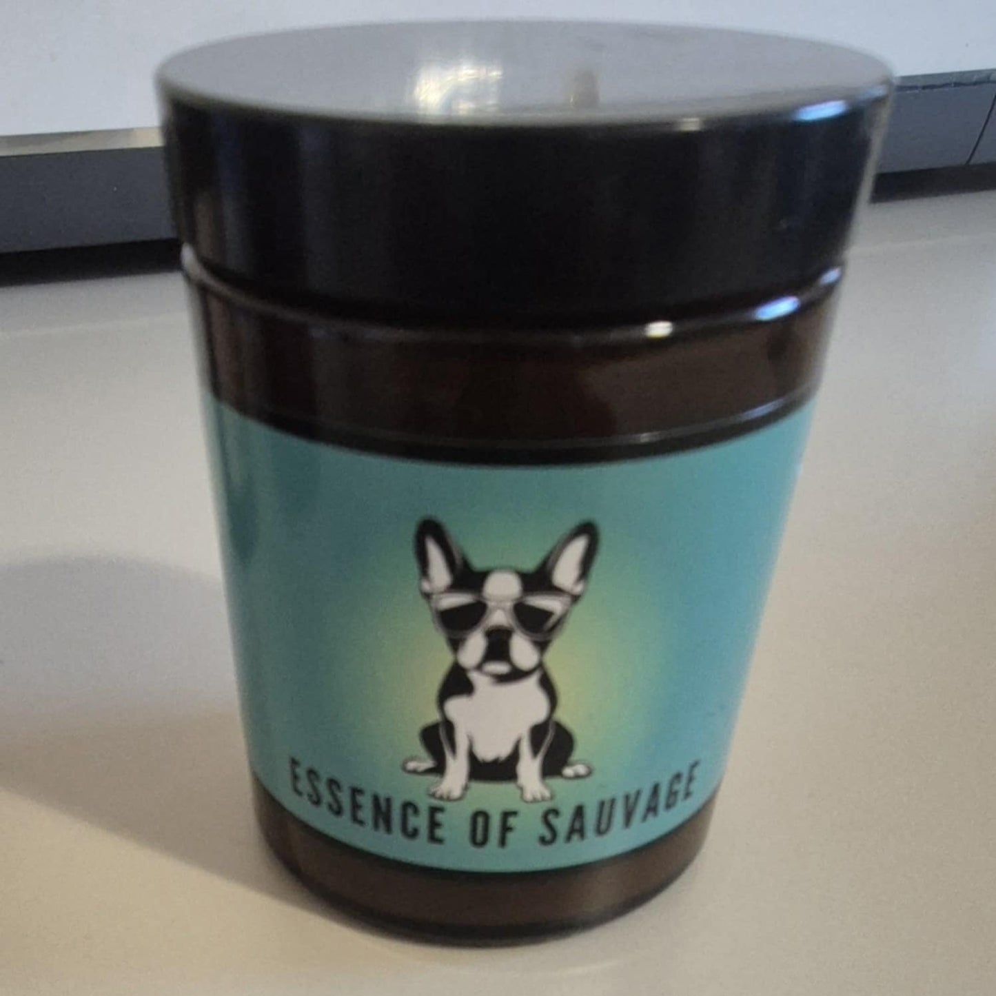 A scented candle with a label that shows palm trees and a beach scene, indicating the fragrance is 'Coconut'.