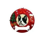 A round ornament with a red wreath design featuring a Boston Terrier in the center, with Christmas decorations such as stars and a snowflake.