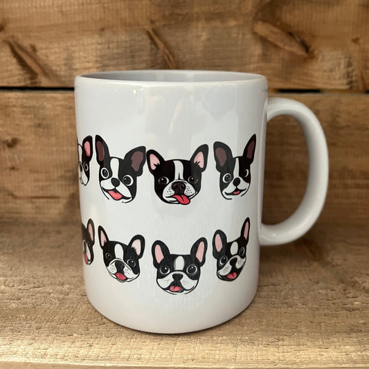White mug with black and white dog pattern on a wooden surface