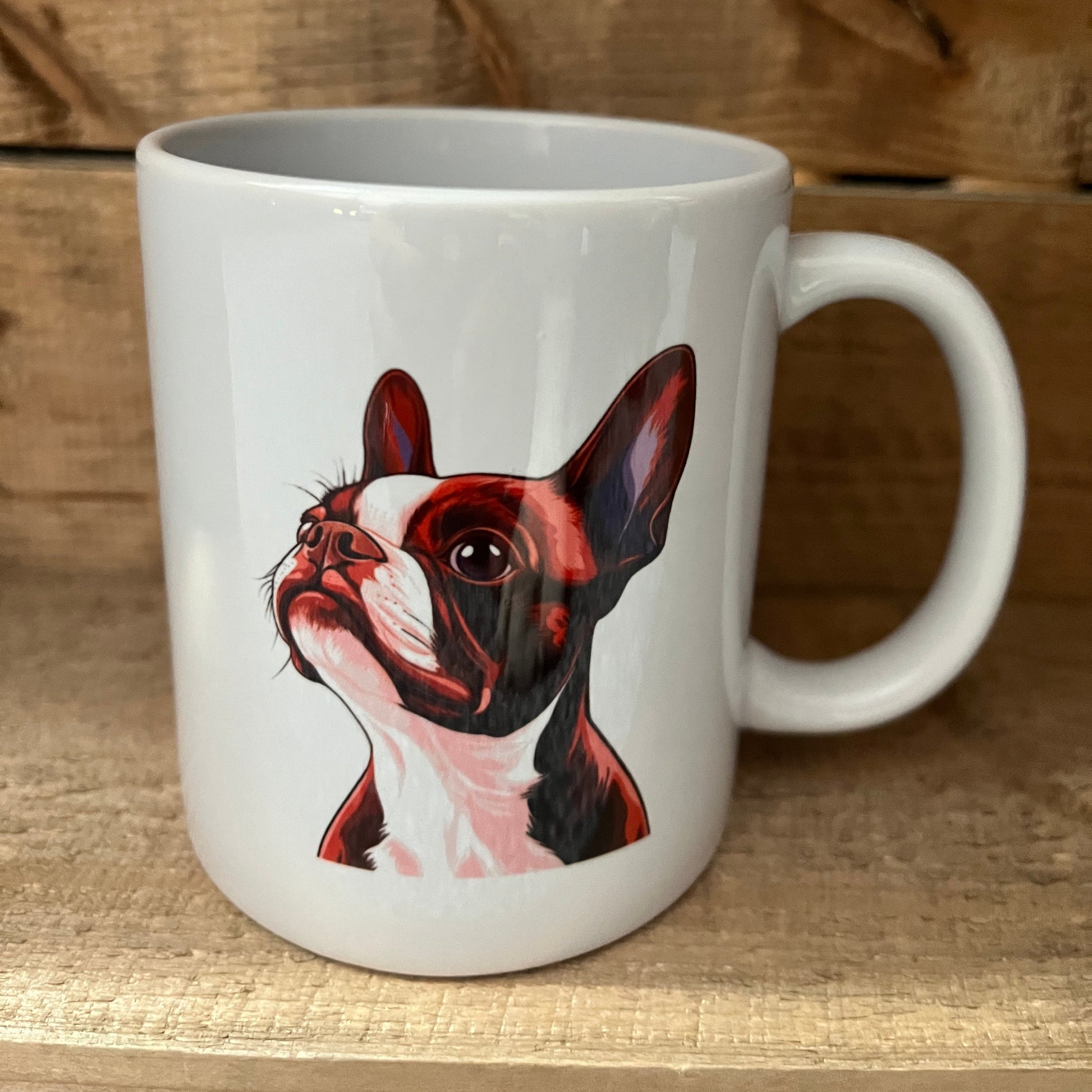 White mug with a dog illustration on a wooden surface